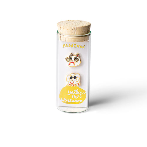 Cat and dog mismatched cloisonné stud earrings by Kristina Micotti in glass vial packaging by Yellow Owl Workshop