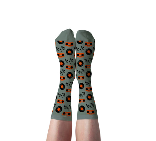 Sage green Music crew socks with vinyl records and boomboxes worn on feet by Yellow Owl Workshop