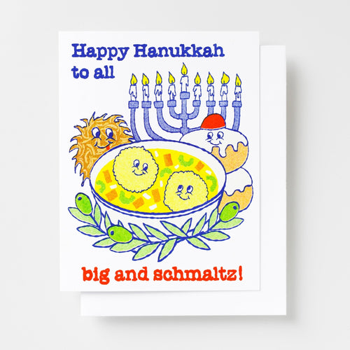 Risograph greeting card with illustrated Hanukkah foods including a bowl of matzo ball soup, latke, and sufganiyah with a menorah and olive branch, text reads Happy Hanukkah to All Big and Schmaltz in blue and red lettering
